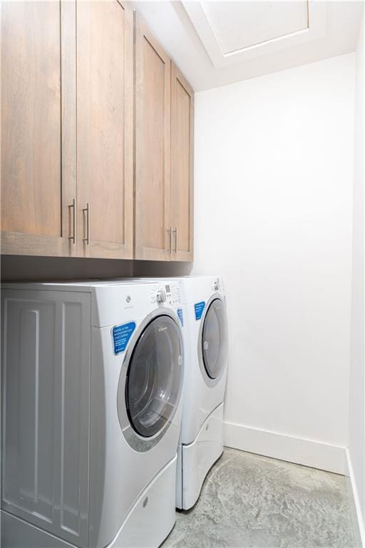 laundry room featuring cabinets and washer and dryer