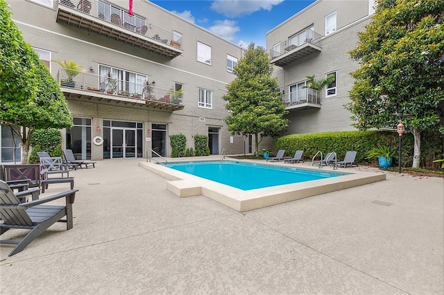 view of swimming pool with a patio area