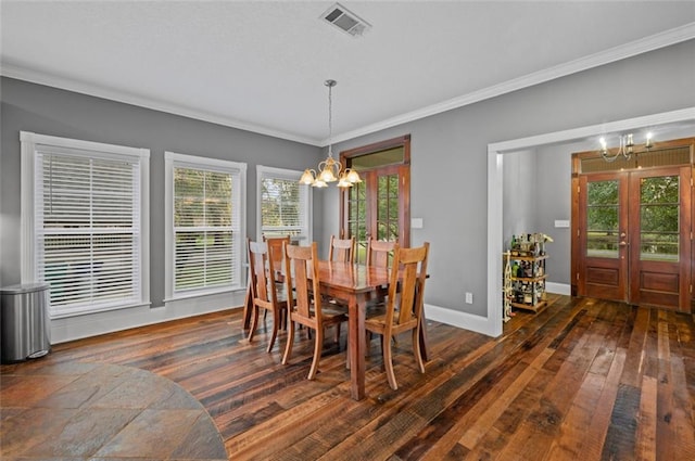 dining area featuring crown molding, french doors, a chandelier, and dark hardwood / wood-style floors