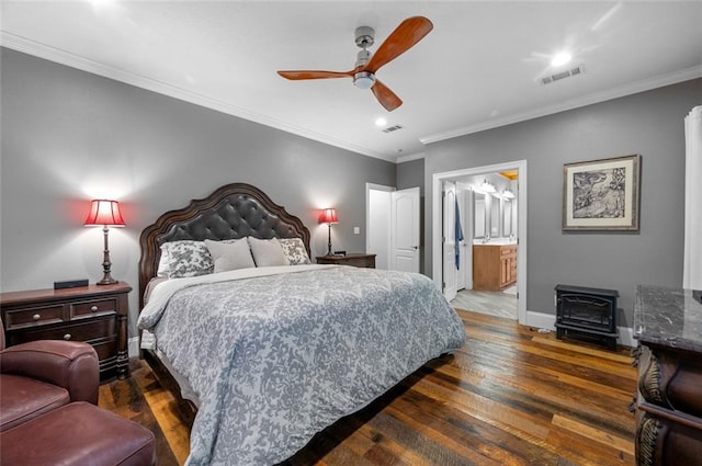 bedroom with connected bathroom, dark hardwood / wood-style floors, ceiling fan, and ornamental molding