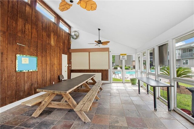 sunroom / solarium with ceiling fan and vaulted ceiling