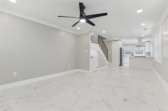 unfurnished living room featuring ornamental molding and ceiling fan