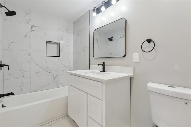 full bathroom featuring vanity, toilet, tile patterned flooring, and tiled shower / bath