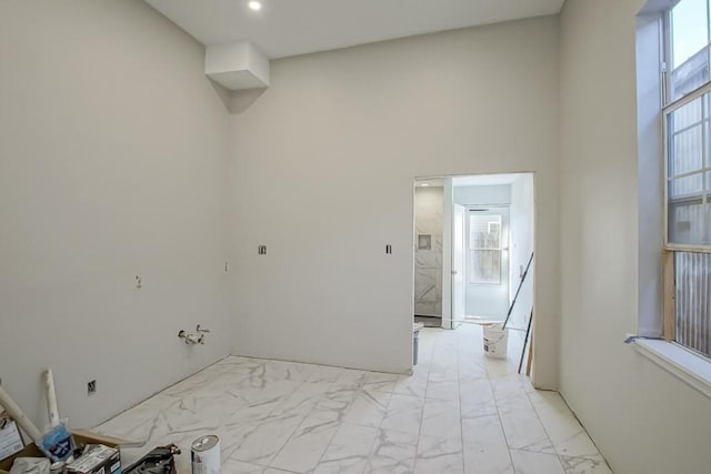 tiled empty room with a towering ceiling