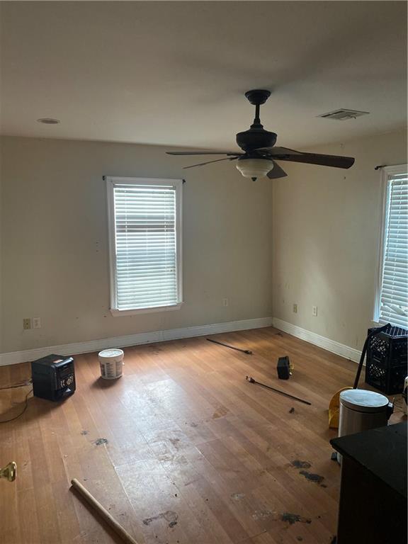 2428 Independence St, New Orleans, LA 70117 - spare room with hardwood / wood-style floors, plenty of natural light, and ceiling fan