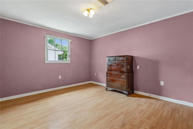 unfurnished bedroom featuring light wood-type flooring and ornamental molding