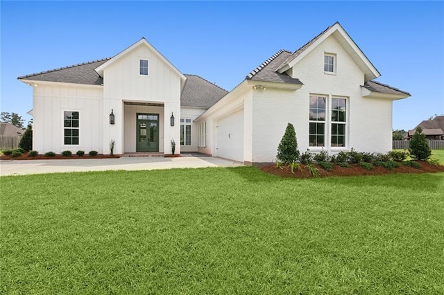 view of front of house with a garage and a front yard