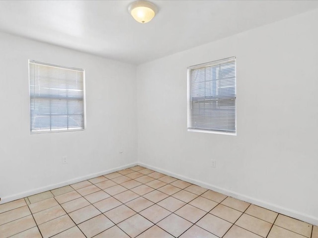tiled empty room featuring a wealth of natural light