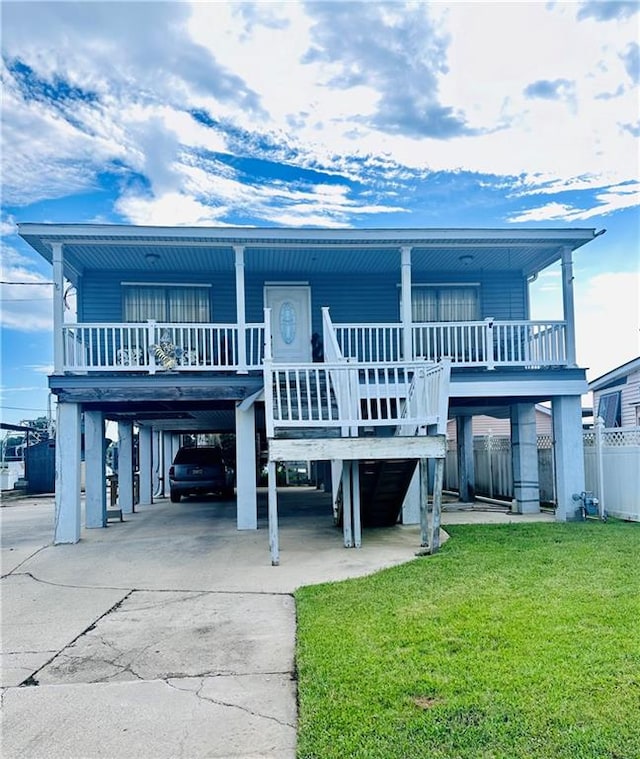 exterior space featuring covered porch, a carport, and a front lawn