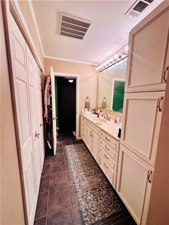 bathroom featuring vanity, crown molding, and tile patterned floors