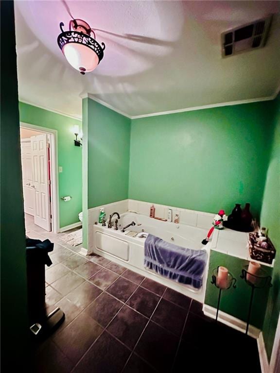 bathroom with crown molding, tile patterned flooring, toilet, and a bath