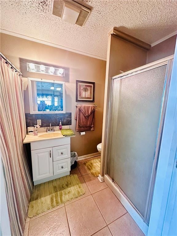 bathroom featuring vanity, tile patterned floors, a textured ceiling, and toilet