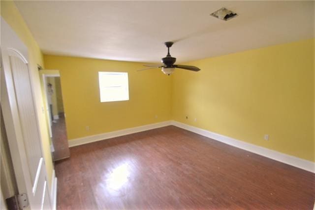 unfurnished room featuring dark hardwood / wood-style floors and ceiling fan