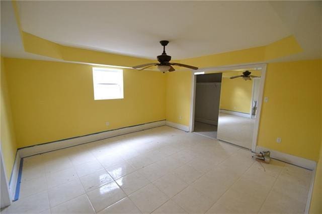 unfurnished bedroom featuring tile patterned flooring, a closet, and ceiling fan