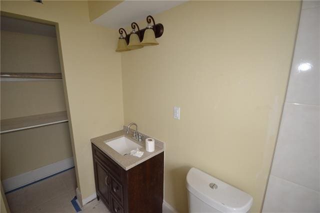 bathroom featuring vanity, tile patterned flooring, and toilet