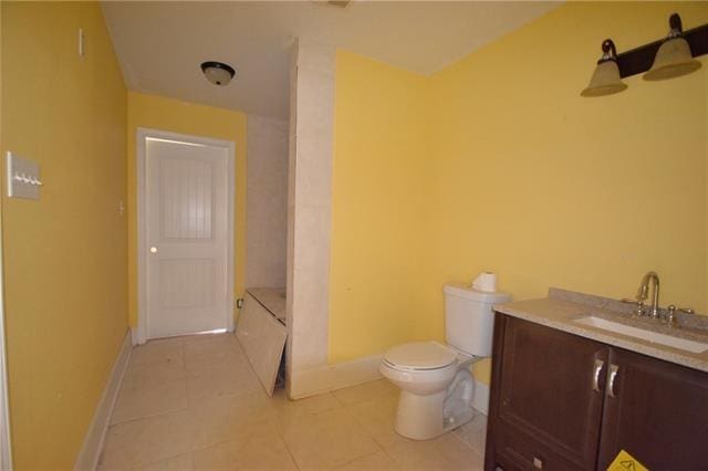 bathroom with vanity, tile patterned flooring, and toilet