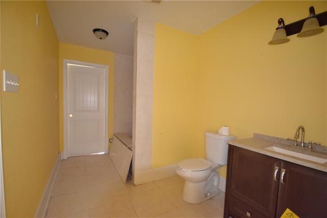 4682 Perrault Walk, New Orleans, LA 70127 - bathroom featuring toilet, vanity, baseboards, and tile patterned flooring