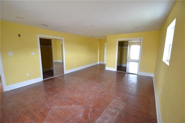 unfurnished room featuring dark wood-type flooring