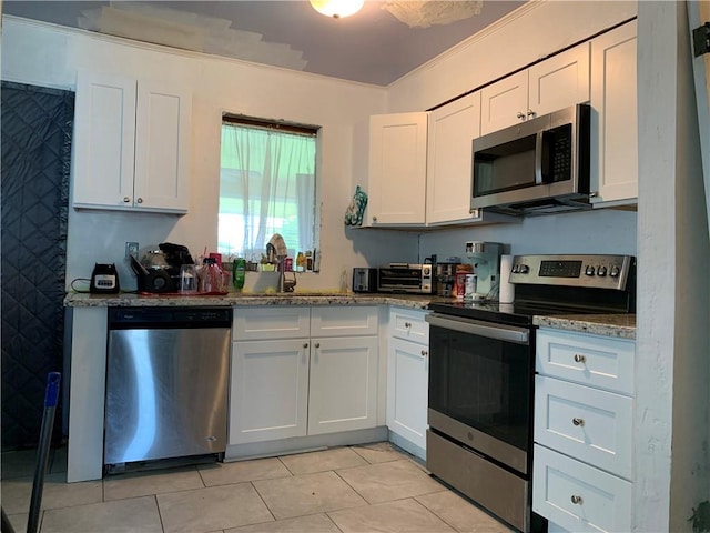 kitchen with sink, white cabinets, and stainless steel appliances