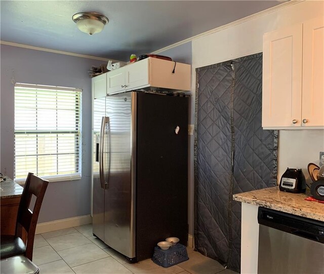 kitchen with white cabinetry, stainless steel appliances, light tile patterned flooring, ornamental molding, and light stone counters