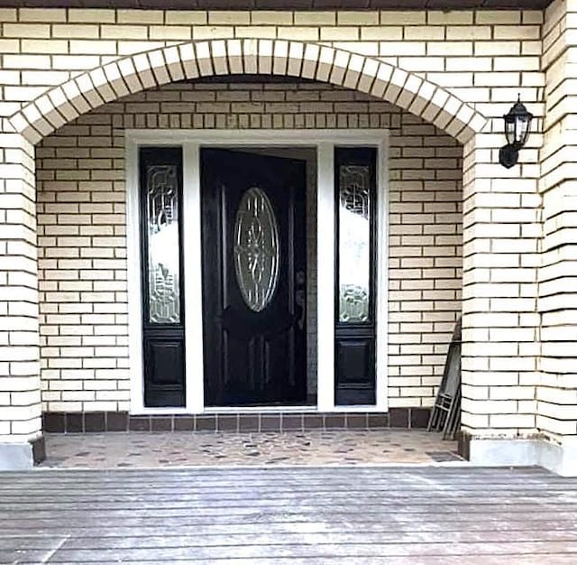 property entrance with brick siding