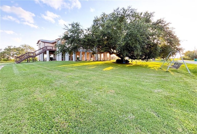 view of yard featuring a wooden deck and stairway