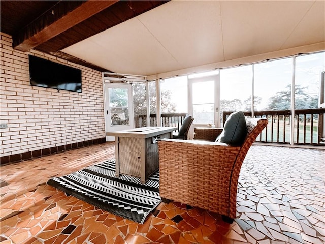sunroom / solarium with brick wall