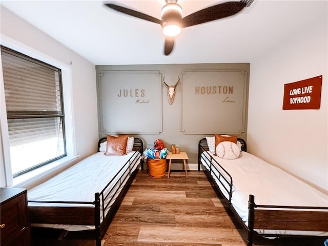 bedroom featuring a ceiling fan and wood finished floors