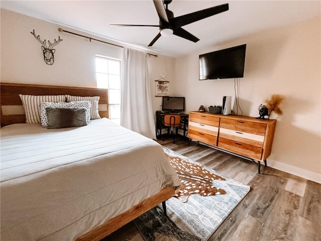 bedroom with hardwood / wood-style flooring and ceiling fan