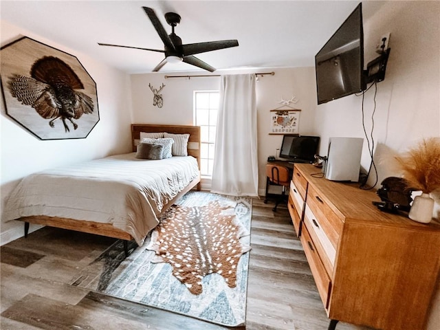 bedroom with ceiling fan and light wood-type flooring