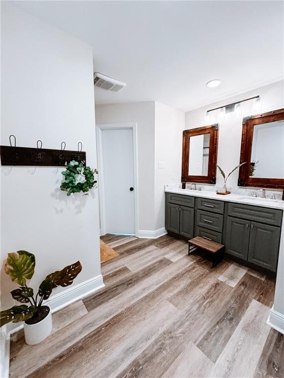 bathroom with wood-type flooring and double sink vanity