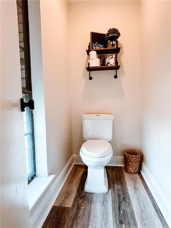 bathroom featuring hardwood / wood-style floors and toilet