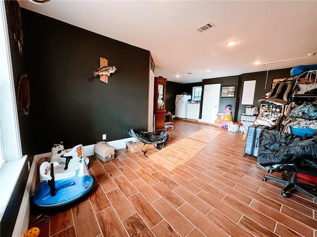 interior space with visible vents, recessed lighting, and wood finished floors