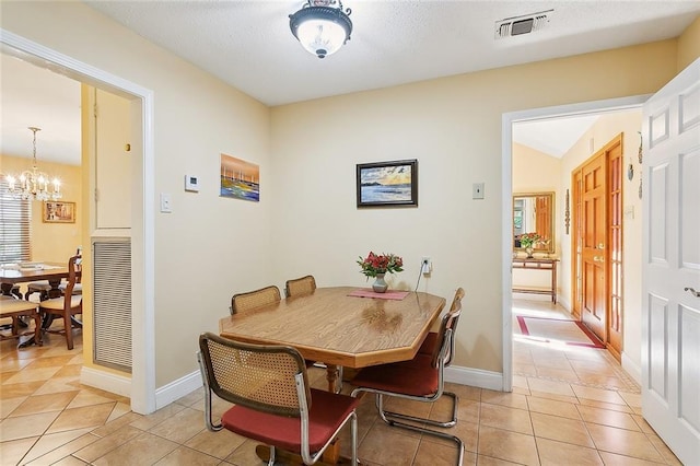 tiled dining area with a notable chandelier