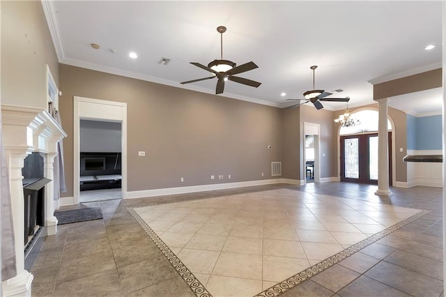 unfurnished living room with ornate columns, light tile patterned floors, ceiling fan with notable chandelier, and ornamental molding