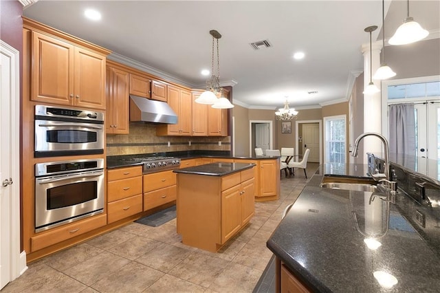 kitchen featuring sink, decorative light fixtures, stainless steel appliances, a center island, and crown molding