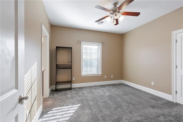 carpeted spare room with ceiling fan