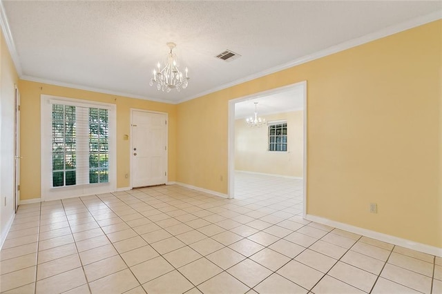 unfurnished room with an inviting chandelier, ornamental molding, and light tile patterned floors