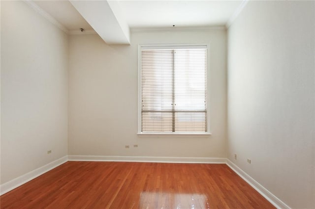 spare room with wood-type flooring and crown molding