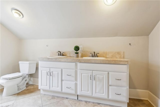 bathroom featuring tile patterned floors, vanity, toilet, and lofted ceiling