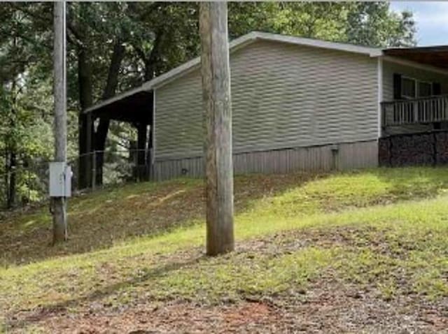 view of side of property featuring a carport