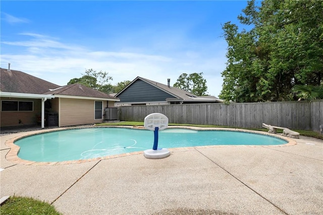 view of pool featuring a patio area and cooling unit