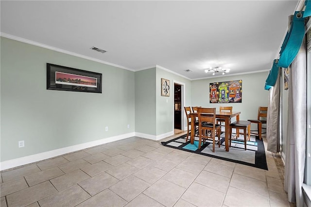 dining area with light tile patterned floors and crown molding