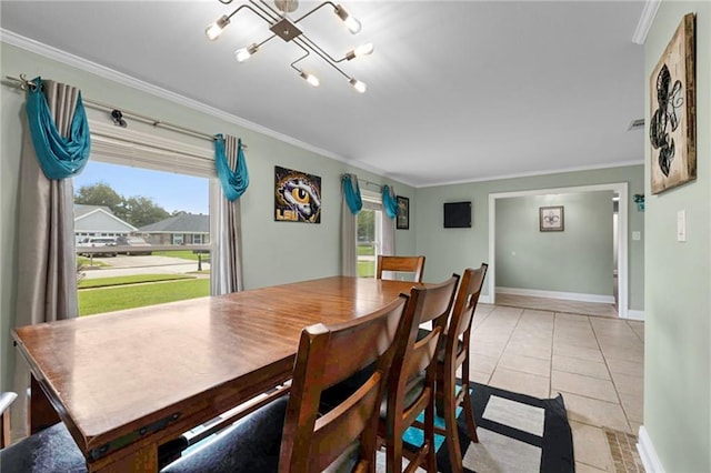 dining area with a wealth of natural light, crown molding, and light tile patterned flooring