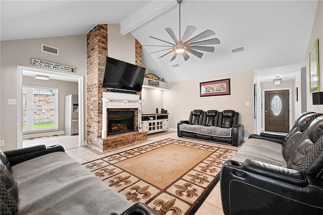 living room featuring ceiling fan, vaulted ceiling with beams, light tile patterned floors, and a brick fireplace