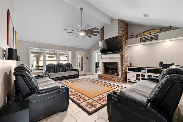 tiled living room featuring ceiling fan, a brick fireplace, and vaulted ceiling with beams