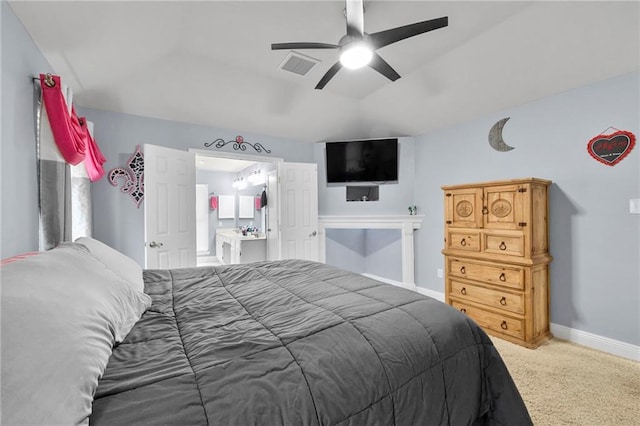 bedroom with ceiling fan, carpet, and ensuite bathroom