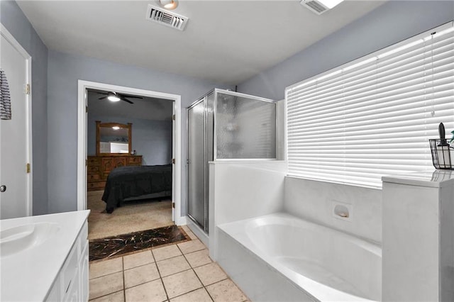 bathroom featuring independent shower and bath, tile patterned floors, and vanity