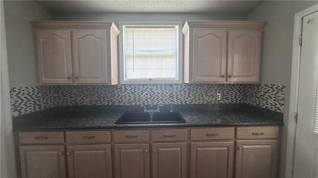 kitchen with backsplash, light brown cabinets, and sink