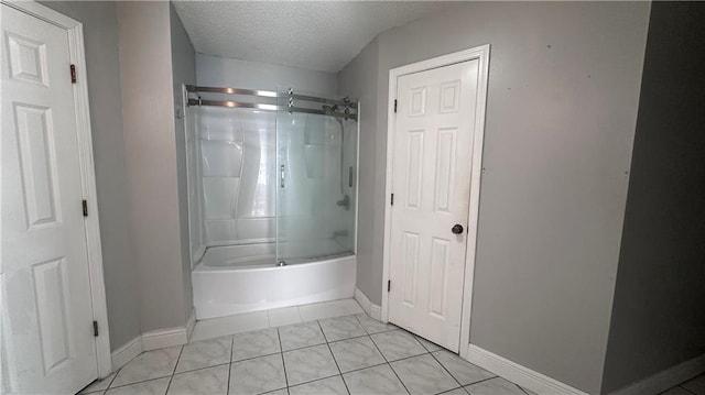 bathroom featuring  shower combination, tile patterned floors, and a textured ceiling